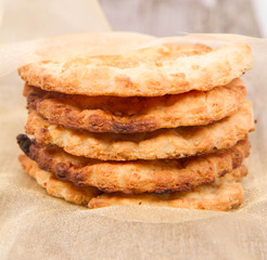 Cookies on a gold cloth on wooden background