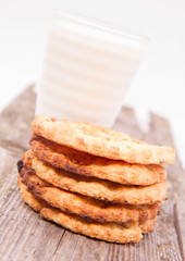 Fototapeta na wymiar Cookies and a glass of milk on wooden background