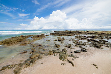 Waves sand beach and clouds sunny day