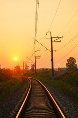 Fototapeta na wymiar Railroad - Railway at sunset with sun