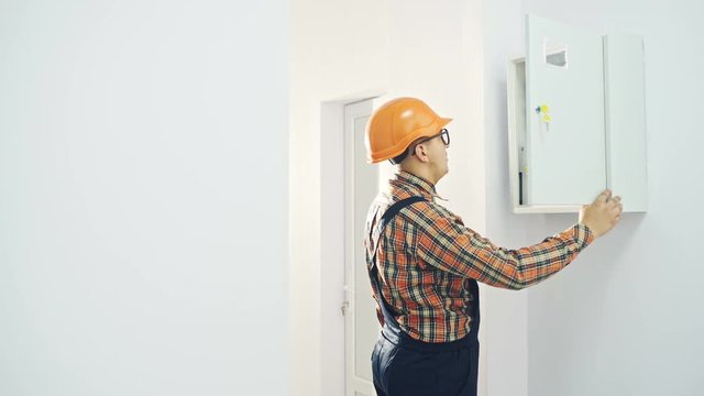 Man inspecting fuse box