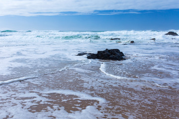 Fototapeta na wymiar View of Guincho Beach, Cascais, Portugal. Empty beach. No people. Beauty in nature. Waves on the Atlantic ocean. Beautiful landscape.