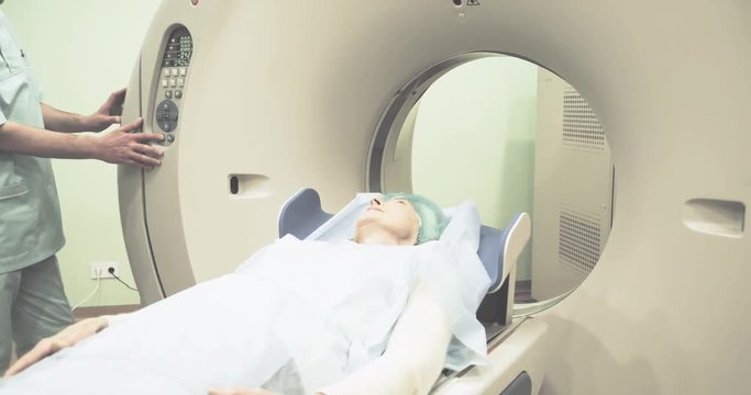 Female patient on CT MRI scanner 4k video. woman moving on computed tomography in diagnostic clinic after test