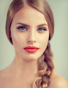 Beautiful young woman  with braid and red lips . Fashion ,beauty and cosmetics
