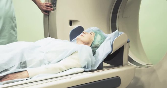 Female patient on CT MRI scanner 4k video. woman moving on computed tomography or magnetic resonance imaging machine  in diagnostic clinic
