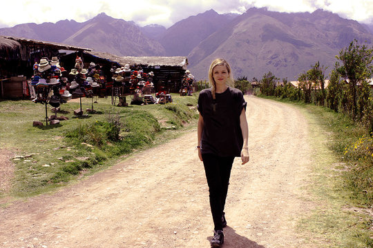 caucasian blond woman walking at dirty road in mountains Peru