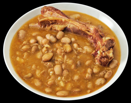 Plateful Of Baked Beans With Smoked Pork Ribs Isolated On Black Background