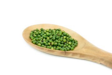 fresh green peppercorns on spoon wood isolated on white