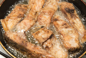 fish is fried in a pan