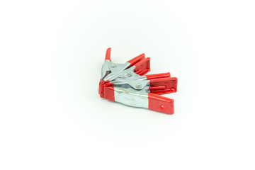 Metal spring clamp with red plastic isolated on white