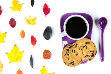 Colourful fall leaves and Purple coffee cup with saucer, spoon isolated on white background