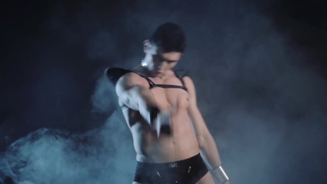 Sexy muscular man dance on dark background. Beautiful body. Sex and passion. Copy space text. Professional color correction.