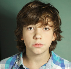 teenager serious boy close up portrait on blue © ulianna19970