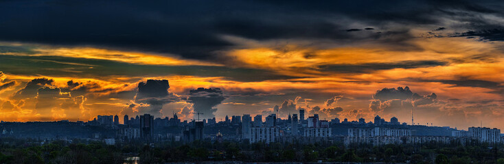 Panoramic view of the big city silhouette against the backdrop of incredibly, awesome bright, colored sunset. Kyiv. Ukraine.