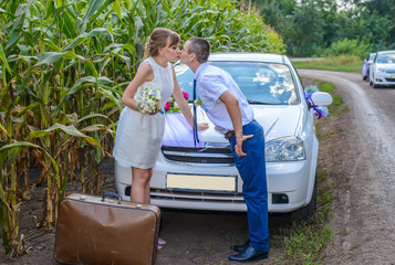 Romantic young bridal couple enjoying a kiss