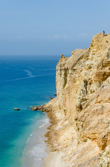 Impressive cliffs with turquoise ocean at the coast at Caotinha, Angola