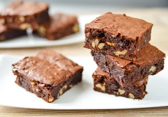 Brownie stack, closeup chocolate cake in plate on rustic wooden © Alexander Demyanenko