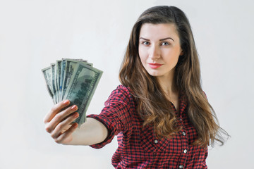young girl holding dollar bills,looking at the camera 