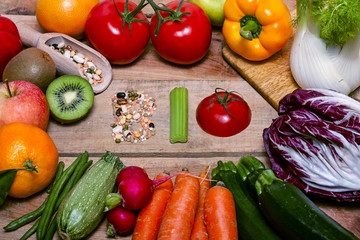 Colorful fruits and vegetables on wood background with word bio