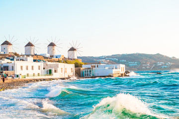 Famous view of traditional greek windmills on Mykonos island at sunrise, Cyclades, Greece - 127529192