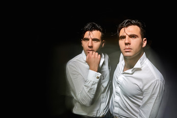 Portrait of a man with a variety of emotions. Double exposition, on a black background.