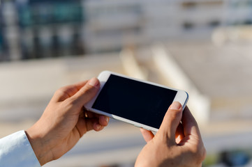 Closeup on smartphone in the hand, copy space background