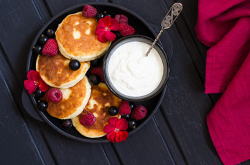 cheese pancakes with berries and yoghurt for breakfast