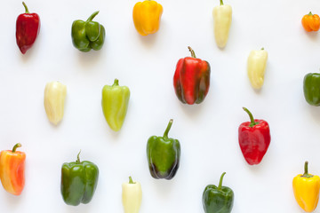 Colorful bell peppers creative arrangement pattern on white