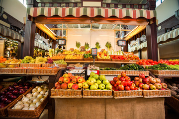 Counters with fresh fruits and vegetables.  - Powered by Adobe