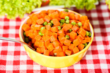 peas and carrots on a spoon