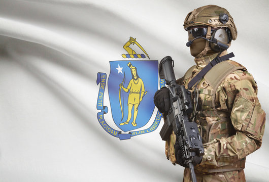 Soldier in helmet holding machine gun with USA state flag on background series - Massachusetts