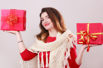 Woman holds red christmas gift boxes