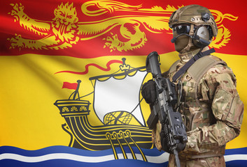 Soldier in helmet holding machine gun with Canadian province flag on background series - New Brunswick