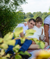 Young newlywed couple relaxing on a rug