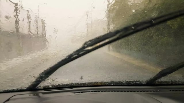 Heavy rain and hail while driving in the city. First person camera from inside the car.