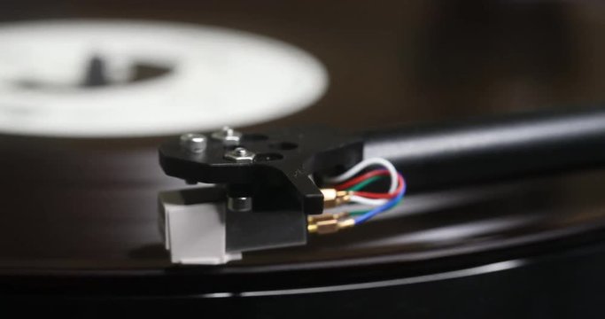 Record player needle dropping on album