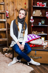 Young girl in the studio with Christmas decorations. Christmas and New Year concept