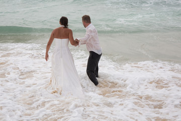 Fototapeta na wymiar Bride and Groom lying in beach shore
