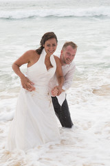 Bride and Groom lying in beach shore