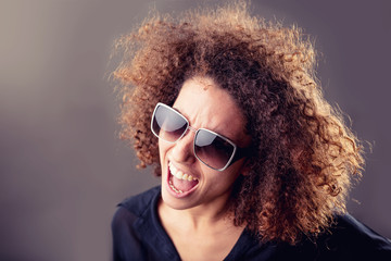 curly haired inspired young woman singing