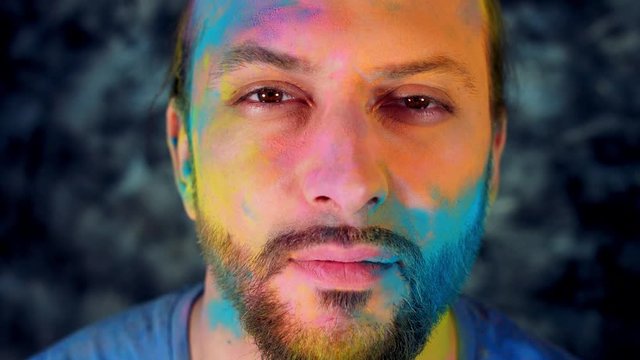 4k Colourful LGBT Shot of a Man in Holy Powder Showing Heart