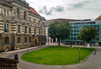Green lawn oval with trees among the houses