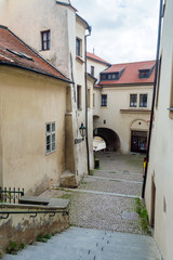View to the small street in courtyard with houses in the old center of Prague