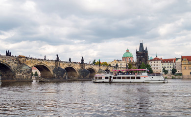 Obraz premium Czech Republic, Charles Bridge across Vltava river on which the ship sails