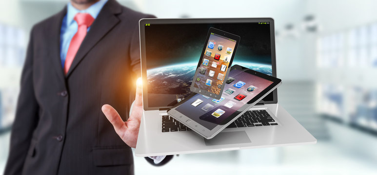 Businessman touching laptop phone and tablet with his finger 3D