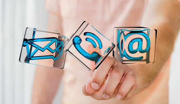 Businessman touching transparent cube contact icon with his fing