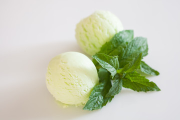 pistachio ice cream with chocolate syrup and mint on a table, selective focus