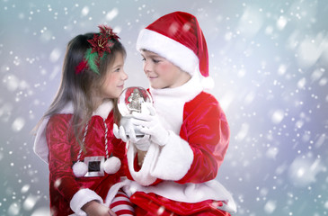 boy and girl as santa and elf