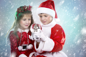 boy and girl as santa and elf
