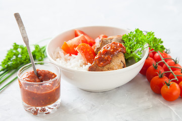 meat a grill and rice with a tomato on a table, selective focus